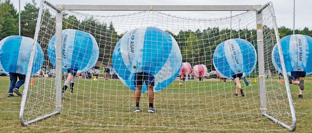 Airmen begin to charge at Soldiers during the kickoff for the Combined Federal Campaign-Overseas’ bubble soccer match Sept. 30 on Ramstein. The kickoff match provided Airmen, Soldiers and their families an opportunity to engage with the CFC-O and learn how they can contribute to helping the local community.