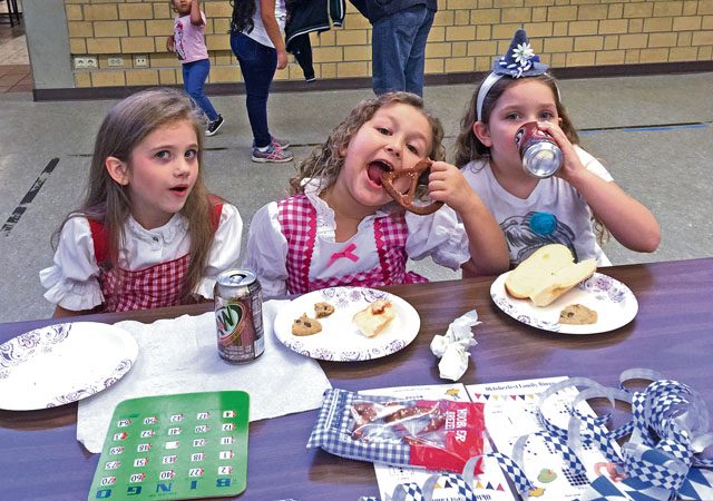 Analise Gaunt (left), Lexi Barnes (center) and Ava Martin take a break from bingo to eat snacks during “Oktoberfest Family Bingo Night” Sept. 30 at Vogelweh Elementary School. Over 100 VES families came out for the school’s first “Oktoberfest Family Bingo Night” as part of a Parent Teacher Student Association fundraiser.