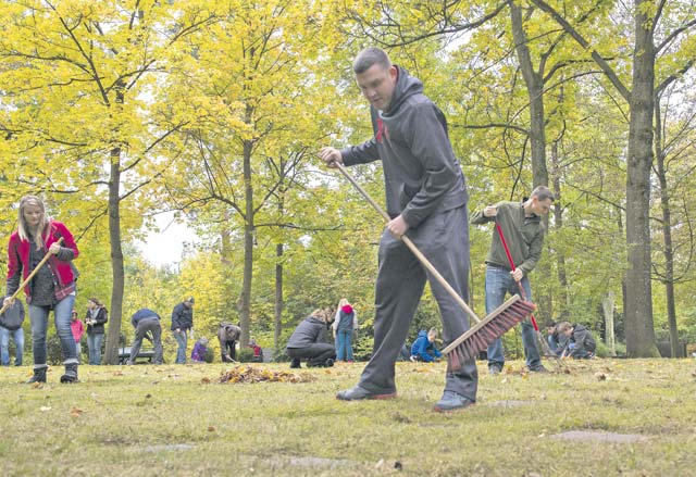 Members of the 86th Operations Support Squadron team clean the American Kindergraves Oct. 15 in Kaiserslautern. The Ramstein Area Chiefs’ Group organizes volunteers to clean the site once a month.