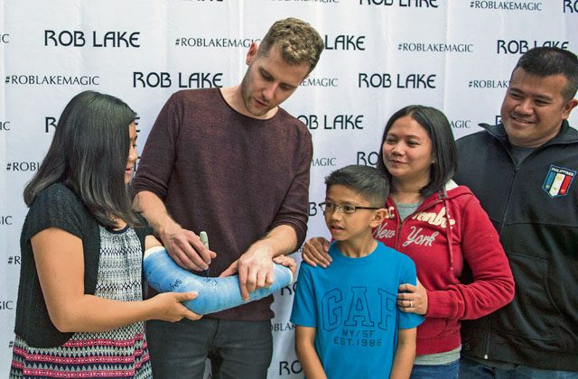 Rob Lake, magician, signs a girl’s cast after a free magic show Sept. 28 on Ramstein. Lake and his team coordinate with Armed Forces Entertainment to perform shows for U.S. military members serving overseas.