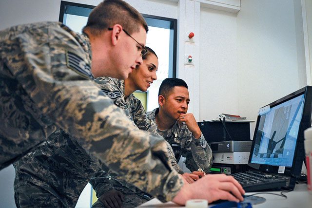 Tech Sgt. Timothy Jenkins (left), Staff Sgt. Silvia Ruiz (middle) and Staff Sgt. Erick Alvarez, 86th Medical Support Squadron radiology diagnostic imaging technicians, check an X-ray Sept. 29 on Ramstein. After an X-ray is taken, it’s examined before being sent to a radiologist at Landstuhl Regional Medical Center.
