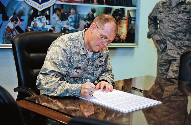Brig. Gen. Richard G. Moore, Jr., 86th Airlift Wing commander, signs a Domestic Violence Awareness Month proclamation Oct. 3 on Ramstein. The proclamation states that domestic violence is a crime that has no place in the Air Force, and that October is Domestic Violence Awareness Month.