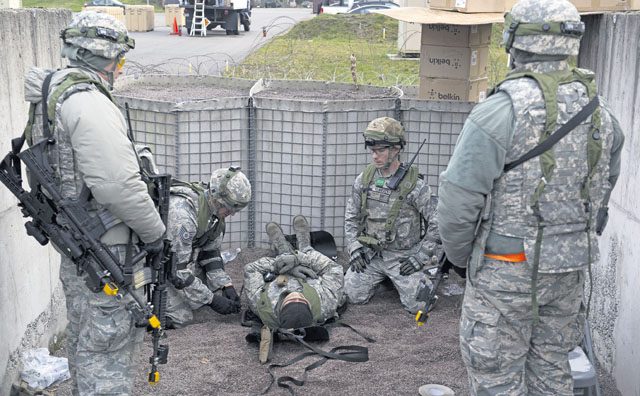 Airmen assigned to the 1st Combat Communications Squadron place an “injured” Airman on a stretcher during exercise Healthy Thunder Nov. 4 on Ramstein. Fifty-eight Airmen participated in the exercise to prepare for a deployment.