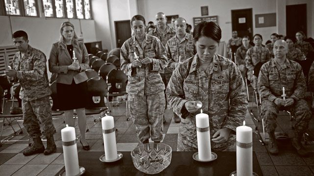 An Airman lights her candle in honor of a victim of interpersonal violence during a candlelight vigil Oct. 27 on Ramstein. According to the Center for Disease Control and Prevention, over the course of a year, more than 10 million U.S. citizens are victims of domestic violence, sexual abuse, child violence and bullying or suicide.