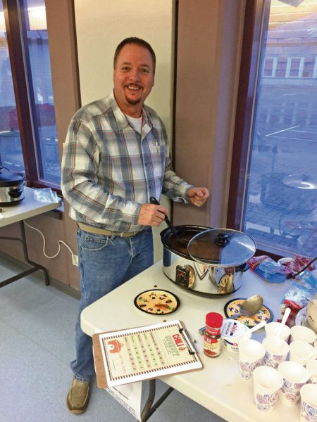 Mike Smith, a teacher and event judge, tastes an entry at the Sembach Elementary School Parent Teacher Organization chili cook-off Oct. 20 at SES. The family of Jonathan Figeroa, a third-grader at SES, was the winner of the chili cook-off.