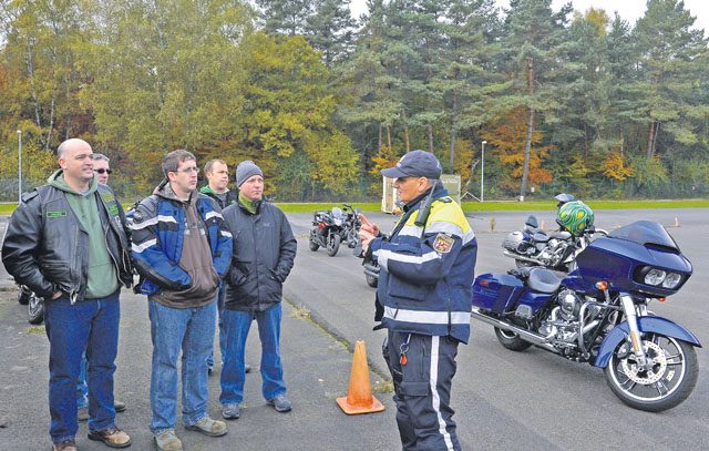 Wolfgang Hanker, chief of the Kaiserslautern Speed Control Unit, explains various motorcycle safety maneuvers to KMC motorcyclists during a safety rally Nov. 4 on Kapaun. The 86th Airlift Wing Safety office arranged for local police to come teach KMC RiderCoaches various safety maneuvers, who would then pass them along to other KMC motorcyclists.