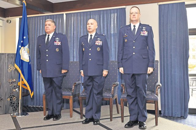 Col. Jonathan Sutherland, U.S. Air Forces in Europe and Air Forces Africa director of communications (left); Col. Curtis Juell, 86th Mission Support Group commander (middle); and Lt. Col. James Huso, 2nd Air Postal Squadron commander, stand at attention during the reading of the reassignment orders at the 2 AIRPS re-designation ceremony Nov. 9 on Ramstein. The ceremony signified the change in designation, assignment and organization of the 2 AIRPS to the USAFE-AFAFRICA AIRPS.