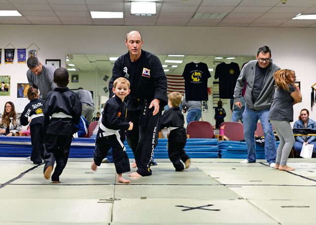 Children practice breaking the grip of a stranger and running away to safety Oct. 22 on Ramstein. Children are taught to get away and find help when encountered by a threatening stranger.