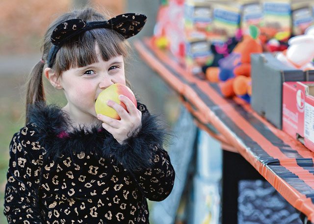 Photo by Senior Airman Jimmie D. Pike Geri Wesley, a Team Ramstein child, eats an apple during the Trunk or Treat event Oct. 31 on Ramstein. The event featured a healthy snack station that served fruits and healthier snack alternatives to candy for kids who had allergies or other dietary restrictions.