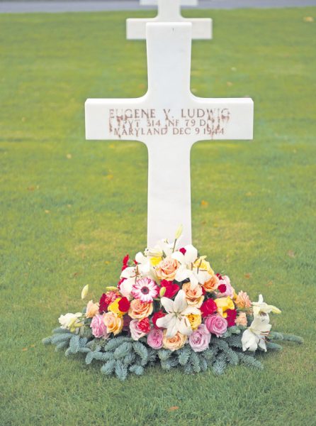 Flowers lay next to a deceased war veteran’s gravestone Nov. 11 at the Lorraine American Cemetery in St. Avold, France. 