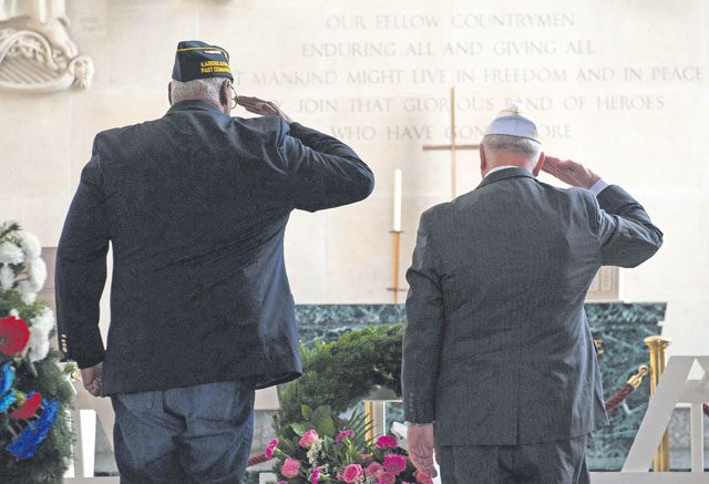 Two war veterans salute the wreaths laid to honor the fallen war veterans buried at Lorraine American Cemetery Nov. 11 in St. Avold, France.