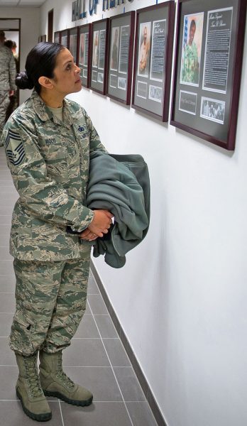 Chief Master Sgt. Roelma Wood, 4th Air Force Installation, Mission Support Center security forces major command functional manager, observes the portrait of a fallen Office of Special Investigations agent during the 25th Expeditionary Field Investigation Squadron’s fallen heroes dedication ceremony Nov. 10 on Ramstein.