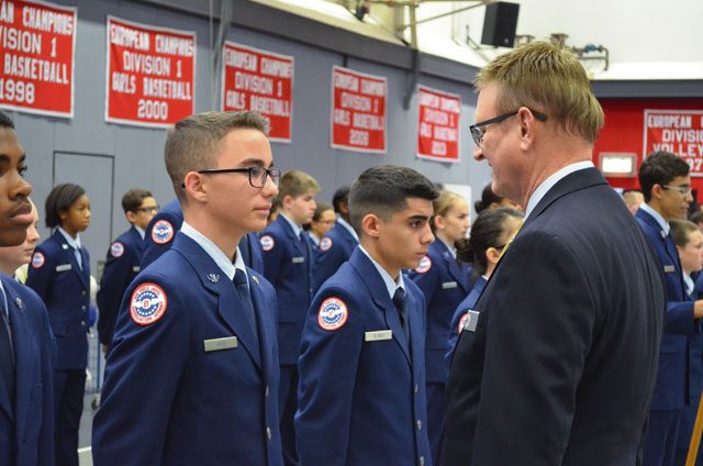 Wayne Barron, inspector, inspects Cadet Airman Eric Wood, ninth-grader at Kaiserslautern High School, during the Headquarters Air Force Junior ROTC evaluation Oct. 25 at KHS on Vogelweh.