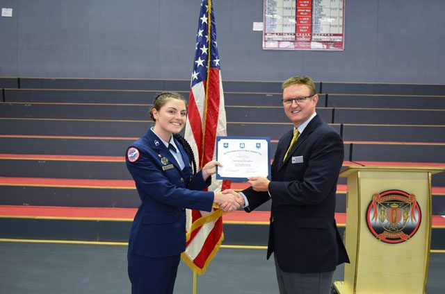 Cadet Maj. Justine Beard, 12th-grader at Kaiserslautern High School, receives the Outstanding Performer award from Wayne Barron, inspector, during the Headquarters Air Force Junior ROTC evaluation Oct. 25 at KHS on Vogelweh. 