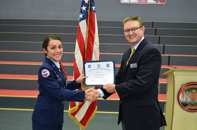 Cadet Maj. Alexiis Figueroa, 12th-grader at Kaiserslautern High School, receives the Outstanding Performer award from Wayne Barron, inspector, during the Headquarters Air Force Junior ROTC evaluation Oct. 25 at KHS on Vogelweh. 