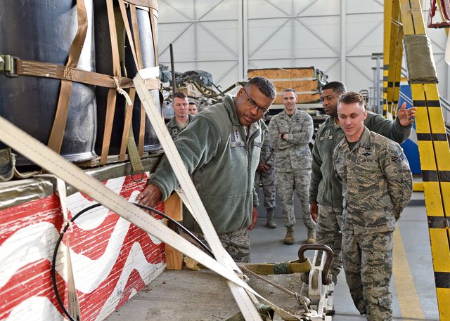 Senior Airman Taylor Still, 86th Logistics Readiness Squadron aerial delivery specialist, shows a recovered air drop load to Lt. Gen. Richard M. Clark, 3rd Air Force and 17th Expeditionary Air Force commander, Dec. 2 on Ramstein. 