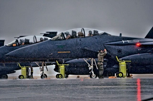 An Airman assigned to Air Combat Command marshals an F-15 Strike Eagle aircraft during a Coronet mission Nov. 10 on Morón Air Base, Spain. This mission will last almost 60 days and is a major Air Expeditionary Force fighter aircraft swap-out between the U.S. and the Middle East.