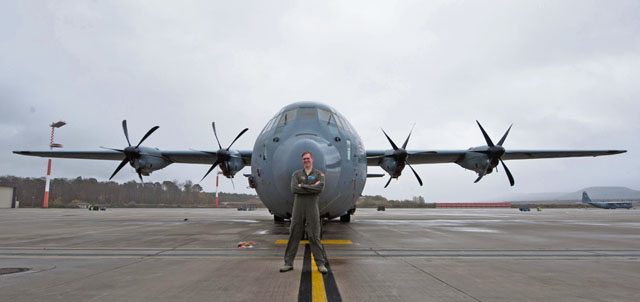 Airman 1st Class Patrick Stone, 37th Airlift Squadron loadmaster, poses in front of a C-130J Super Hercules Nov. 17 on Ramstein. Stone, along with wingman Staff Sgt. James Gaston, 37 AS loadmaster, worked together to create a new repair program within their unit, which salvages usable parts from nonfunctional headsets to create complete units. In the first iteration of their program, Gaston and Stone were able to assemble nine fully functional headsets from individual components, thus reducing the number of new headsets needing to be purchased. Together, they saved the Air Force $8,100.