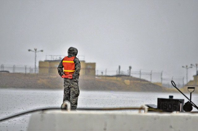 An Airman assigned to the Air Mobility Command stands ready to marshal a KC-135 Stratotanker aircraft Nov. 10 prior to its departure from Morón Air Base, Spain. 