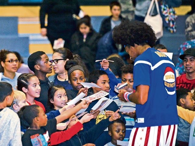 A Harlem Globetrotter signs autographs after a game Nov. 10 on Ramstein. The basketball exhibition group has been performing for U.S. troops overseas for more than 10 years.