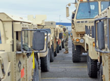 Photo by Staff Sgt. Elizabeth Tarr
An 18th Combat Sustainment Support Battalion, 16th Sustainment Brigade Soldier lines up tactical military vehicles prior to a convoy Jan. 7 at the staging area across the street from the port in Bremerhaven, Germany. Soldiers from the 16th Sustainment Brigade assisted 3rd Armored Brigade Combat Team, 4th Infantry Division, with offloading the heavy brigade’s equipment from cargo ships in this North Sea port city and transporting them to the Bergen-Hohne Training Area railhead almost 100 miles inland from Jan. 6 to 18.