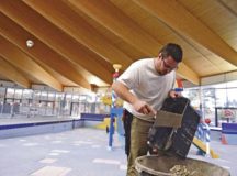 Christian Kampa, 786th Civil Engineer Squadron structural maintainer, dumps old mortar into a bin while doing maintenance work at the Ramstein Aquatic Center Dec. 15. Maintenance work included replacing old tiles in the pools, redoing grout work and replacing old slides in the children’s area.