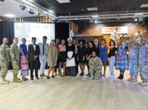 Kaiserslautern middle and high school students, who performed during the 21st Special Troops Battalion’s Black History Month presentation, and guest speaker Sgt. Asi Dzietror stand with the 21st Theater Sustainment Command commander following the event Feb. 10 at Kazabra Club on Vogelweh.