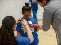 U.S. Army Sgt. Brenda Contreras, 5th Quartermaster, 21st Special Troops Battalion, 21st Theater Sustainment Command, pins a ribbon on Aviella, a special Olympian, May 19 on Ramstein. Aviella and the other students competing in the 2017 Spring Kaiserslautern Military Community Special Olympics received a volunteer to accompany them as a “buddy” throughout the day.