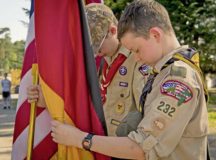 Children of Ramstein personnel who are members of the Boy Scouts of America bow their heads in respect during the invocation at a Flag Day flag disposal ceremony June 14 on Ramstein.