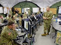 Master Sgt. Pierre Brudnicki, right, speaks to the battle staff during the 7th Mission Support Command’s Command Post Exercise May 12 at Panzer Kaserne.