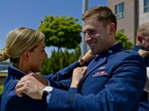 Capts. Haley Wilson, 603rd Air Operations Center strategy division officer, left, and Kevin Durr, Warrior Preparation Center program manager, pin their new ranks on each other during their promotion ceremony May 26 on Ramstein. The ceremony was presided over by Lt. Gen. Richard M. Clark, 3rd Air Force commander.