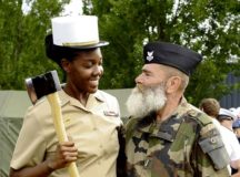 A U.S. Navy Sailor and a member of the Armee de Terre switch hats for a photo July 12 at Camp de Satory, France. During rehearsals, military members from different countries had the opportunity to interact and learn from the other’s military traditions and culture, further strengthening the bond between old allies.