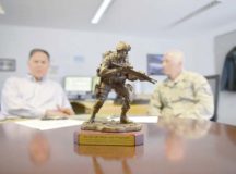 A trophy for the 86th Airlift Wing Plans and Programs office stands in the middle of a table during a meeting July 26 on Ramstein. The 86th AW XP office integrates information and creates solutions concerning missions and operations coming in and out of Ramstein. The office acts as a liaison between incoming missions and the agencies they need to meet.