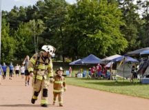 Master Sgt. Michael Ott, Air Force Installation and Mission Support Center Detachment 4 Fire Emergency Services program manager, and his son, Aaron, run a lap during the 11th annual Kaiserslautern Military Community Viking Challenge July 28 on Vogelweh. Approximately 600 participants came to walk, run and camp during the 24-hour run and walk-a-thon. — Photo by Airman 1st Class Milton Hamilton Jr.