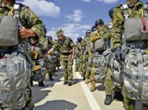 A Romanian military member inspects his troops as they prepare to board a C-130J Super Hercules during a bilateral training exercise with U.S. forces Aug. 24 at Boboc Air Base, Romania. U.S. and Romanian troops joined forces for Carpathian Fall, which aims to promote interoperability and unit cohesion among allies.