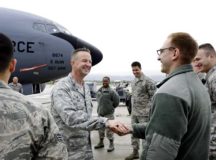Col. Clifton Reed, 6th Maintenance Group commander, coins an Airman from the 86th Maintenance Squadron Oct. 2 on Ramstein Air Base. Reed paid a visit to Ramstein to personally thank 86th MXS Airmen that helped repair a KC-135 Stratotanker from MacDill Air Force Base, Fla.