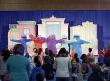 Sesame Street characters sing a song to the audience at the USO’s Sesame Street Tour Oct. 5 on Ramstein Air Base. The show consisted of a medley of songs and dances, teaching military children how to adjust to frequent changes in their lives.