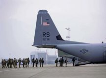 Paratroopers with the U.S. Air Force, U.S. Army, and German Air Force prepare to board a U.S. Air Force C-130J Super Hercules Dec. 6 on Ramstein Air Base. The paratroopers participated in Operation Toy Drop 2017 to maintain their military free fall and jump master proficiencies. — Photo by Senior Airman Devin M. Rumbaugh