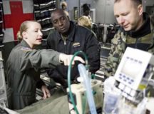 Senior Airman Shelby Lucas, 10th Expeditionary Aeromedical Evacuation flight critical care transport team respiratory therapist, explains the role of a critical care air transport team to Partnership Flight Symposium participants Jan. 17 on Ramstein Air Base. The CCATT’s mission is unique, as it’s staffed to operate an intensive care unit in an aircraft during flight. — Photo by Tech. Sgt. Rachelle Coleman