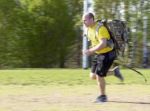 A member of the Kaiserslautern Military Community runs with a rucksack during the Courage, Leadership, Education, Advocacy and Respect challenge obstacle course April 20 on Ramstein Air Base. The rucksack signifies the burden a victim can feel during their journey to recovery.