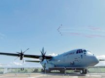 A Spanish aerobatic demonstration team flies in formation while a U.S. Air Force C-130J Super Hercules from Ramstein Air Base sits on display April 25 during the Berlin Air and Trade Show. The Berlin Air and Trade Show provides a medium for U.S. and allied nations to exchange information and enhance interoperability.