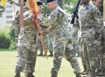 Command Sgt. Maj. Alberto Delgado, outgoing command sergeant major of the 21st Theater Sustainment Command, hands the command’s guidon back to Maj. Gen. Steven A. Shapiro, 21st TSC commanding general, during a change of responsibility ceremony May 18 at Daenner Kaserne. Delgado relinquished responsibility as the two-star command’s senior enlisted advisor to Command Sgt. Maj. Rocky Carr, who becomes the command’s 17th command sergeant major. Delgado will assume responsibility of command sergeant major for U.S. Army North, a three-star command. Photo by Sgt. 1st Class Jacob McDonald