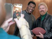 Herschel Walker has a photo taken with a Team Ramstein member at the Officer’s Club on Ramstein Air Base, Jan. 9. Walker visited the Kaiserslautern Military Community to share his struggles and successes with his mental health while encouraging those he met to seek out help if they need it. 