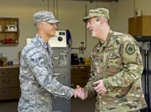U.S. Air Force Brig. Gen. Mark R. August, 86th Airlift Wing commander, presents a coin to Airman 1st Class Justin Serna, 786th Civil Engineer Squadron locksmith apprentice on Ramstein Air Base, April 25. Serna received the honor of being Ramstein’s Airlifter of the Week.