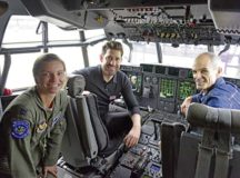 American actors John Krasinski and Michael Kelly sit in a cockpit with U.S. Air Force Capt. Korie Roberts, 37th Airlift Squadron instructor pilot, during a base tour on Ramstein Air Base,  Oct. 15.