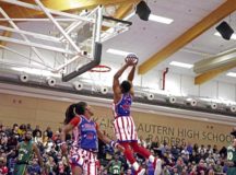 A member of the Harlem Globetrotters dunks a basketball at the Harlem Globetrotters Germany Tour on Vogelweh Military Complex, Nov. 15. The team performed two shows for the Kaiserslautern Military Community. Photo by Senior Airman Milton Hamilton