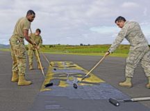 U.S. Air Force Airmen from the 786th Civil Engineer Squadron paint over runway markings at Lajes Field, Portugal, Dec 12. The changes get the landing zone one step closer to being certified and operational. Photo by Ricky Baptista