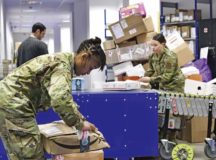 Airmen handle parcels that arrive in need of repackaging at the Northside Post Office, Ramstein Air Base, Dec. 6. Volunteer support during the holidays helps military postal clerks give more immediate attention to mail requiring quality control. Photo by Airman 1st Class John R. Wright