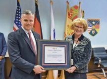 Installation Management Command-Europe Director Tommy Mize presents the 2019 Norman H. Marcus Award to Ingrid Osewalt, U.S. Army Garrison Rheinland-Pfalz Family and Morale, Welfare and Recreation program analyst and acting deputy director, during a ceremony Feb. 12. Osewalt was recognized for making significant and lasting enhancements in MWR programs across Europe during her 33 years of service.