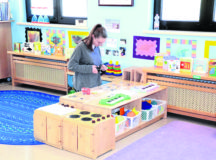 Nicole Radek, Miesau Army Depot Child Development Center staff member, replaces decorations that were scraped off of furniture in a CDC classroom during deep cleaning as a precaution against COVID-19.